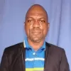 picture of olanrewaju alege dressed in a black jacket and stripped polo shirt
